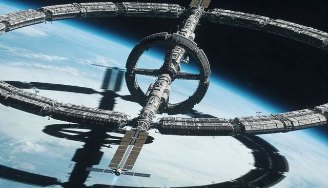 Rotating orbital ring station casting shadow over Earth, docking spacecraft