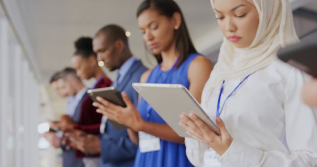 Diverse Group Using Tablets in Line - Download Free Stock Images Pikwizard.com