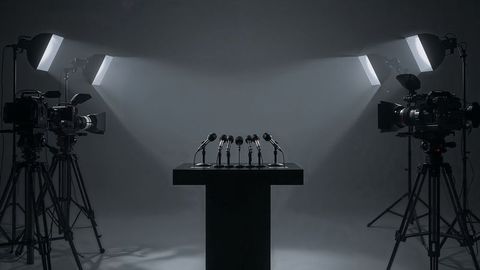 Broadcast podium with microphones and camera equipment