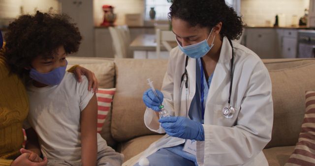 Nurse Preparing Vaccine for Child Sitting on Sofa at Home - Download Free Stock Images Pikwizard.com