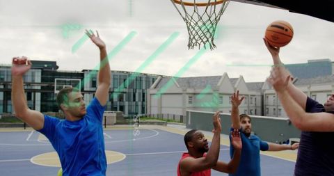 Urban outdoor basketball players reaching for hoop on campus court during intense jump shot