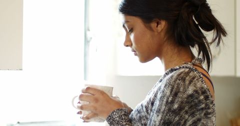 Woman Enjoying Coffee in Relaxed Morning at Home Kitchen