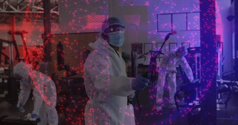 Health Professional Disinfecting Gym Equipment