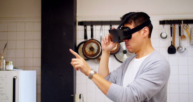 Man Using Virtual Reality Headset in Kitchen - Download Free Stock Images Pikwizard.com