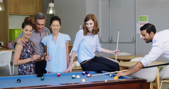 Colleagues Enjoying Game of Pool in Office Lounge - Download Free Stock Images Pikwizard.com