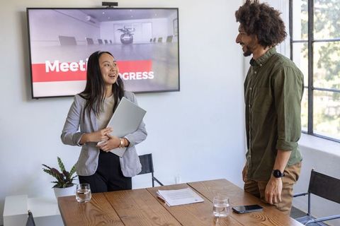 Diverse Coworkers Discuss Progress in Modern Office