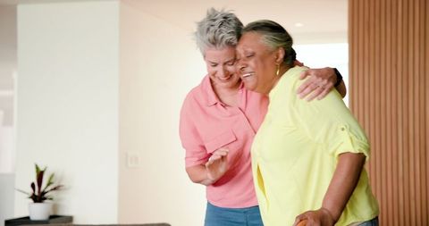Joyful Senior Lesbian Couple Sharing Light Moment at Home