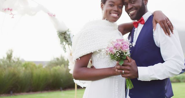 Portrait of happy african american couple embracing during wedding. Wedding day, friendship, inclusivity and lifestyle concept.