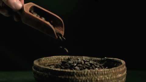 Wooden Scoop Pouring Coffee Beans into Basket
