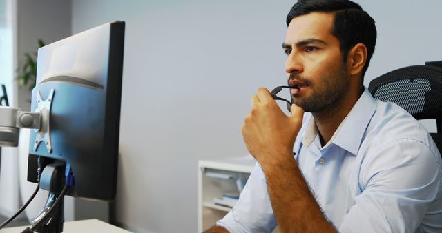 A middle-aged Caucasian businessman is focused on his computer screen, with copy space - Download Free Stock Photos Pikwizard.com