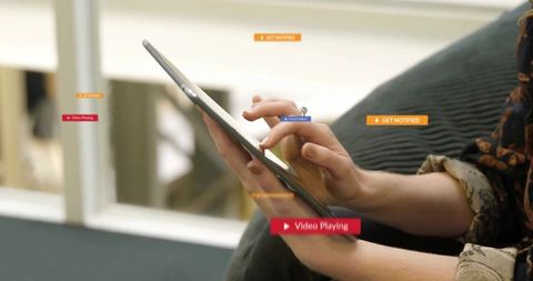 Woman engaged with tablet device in modern lounge environment