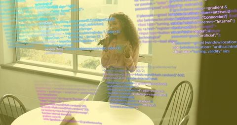 Woman in modern workspace engaging with digital code interface