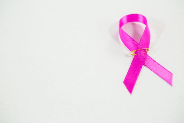High angle view of pink Breast Cancer ribbon on white background