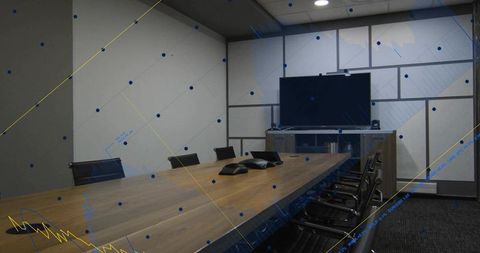 Modern conference room featuring long wooden table with dual speakerphones and wall monitor