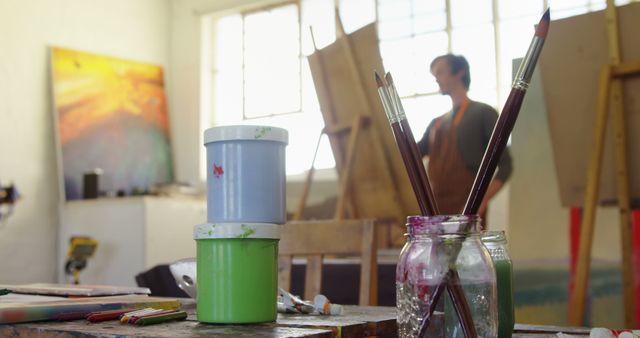 Artist Working in Bright Studio with Painting Supplies - Download Free Stock Images Pikwizard.com