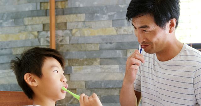 Father and Son Brushing Teeth Together in Bathroom, Daily Hygiene Routine - Download Free Stock Images Pikwizard.com