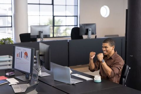 Energetic Professional Celebrating Success in Modern Office Environment