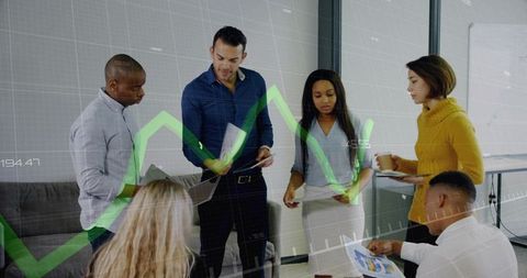 Multicultural team discussing analytics and growth charts during business meeting