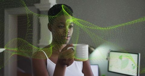 Woman in Home Office Holding Mug and Gazing at Data