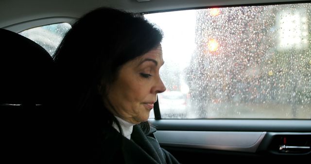 Businesswoman Sitting in Car on Rainy Day - Download Free Stock Images Pikwizard.com