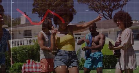 Friends dancing at sunny backyard summer party with ukulele and picnic