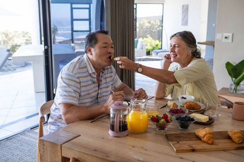 Elderly Couple Sharing Romantic Breakfast at Home