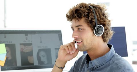 Creative professional wearing headset working at desk
