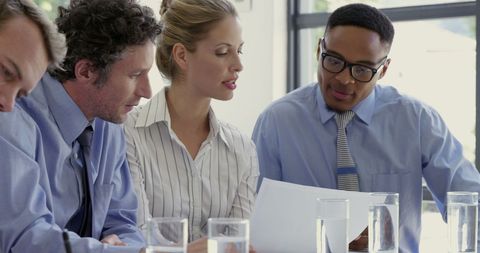 Diverse Team Collaborating on Business Documents - Download Free Stock Images Pikwizard.com