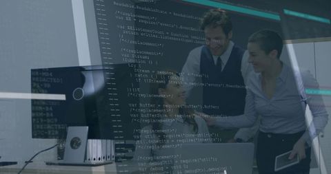 Tech team collaborating on code review in modern office with laptop, tablet and desktop monitor