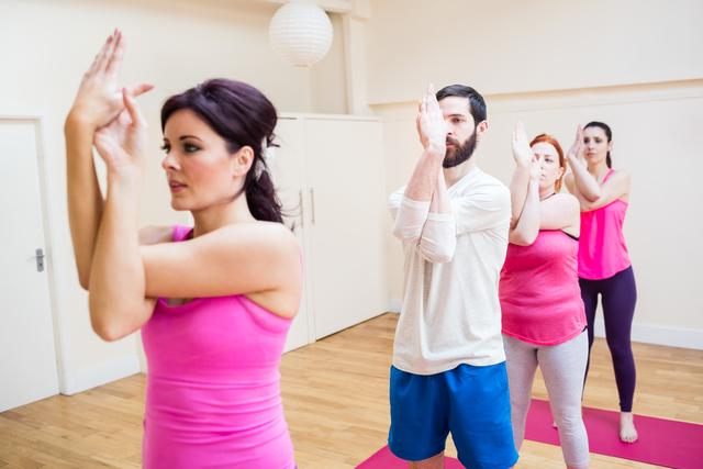 Group of people performing hand exercise in the fitness studio