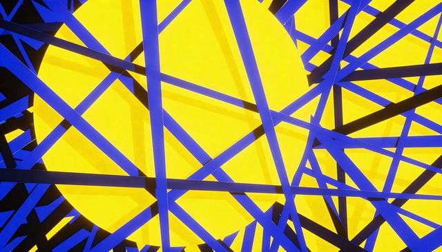 Yellow disc intersecting blue black geometric beams high-contrast abstract composition