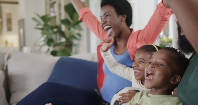 Joyful African American Family Cheering and Celebrating at Home - Download Free Stock Images Pikwizard.com