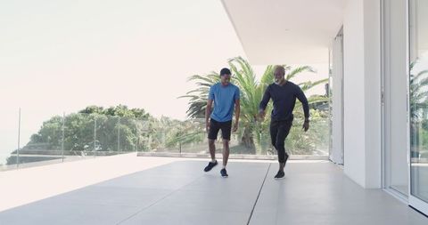 Trainer and Client Workout on Contemporary Terrace with Ocean View