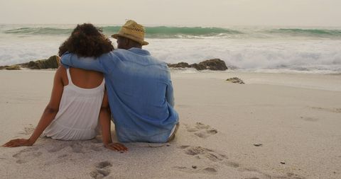 Romantic Couple in Embrace on Beach Watching Waves at Sunset - Download Free Stock Images Pikwizard.com