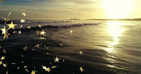 Golden Sunset Over Crashing Waves with Star Overlays