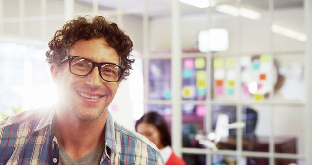 Smiling Man in Glasses with Team in Office Setting - Download Free Stock Images Pikwizard.com