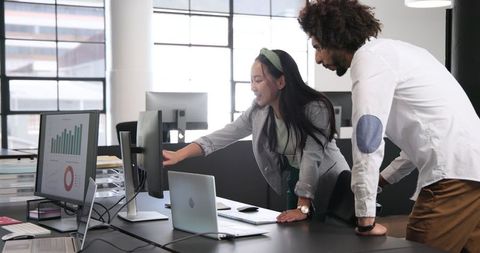 Multicultural Team Discussing Data in Modern Office