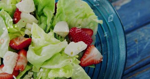 Fresh Salad with Strawberry, Lettuce, and Cheese in Blue Bowl