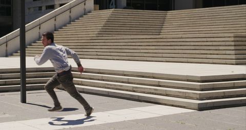 Urban athlete exploring parkour in sunlit city
