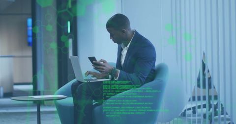 African American Businessman Analyzing Data on Laptop in Modern Office