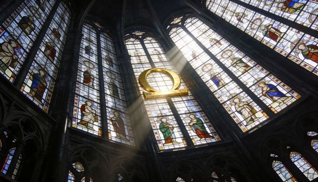 Gilded omega emblem bathing gothic cathedral apse in sunbeams through stained glass