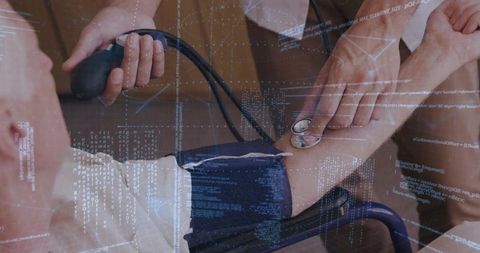 Clinician measuring blood pressure on senior patient with digital health data overlay