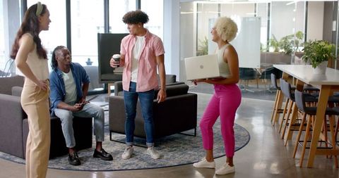 Diverse Team Having Casual Conversation in Modern Office