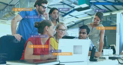 Diverse Team Engaged in Office Technology Collaboration