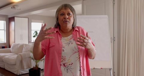 Woman Giving Presentation in Cozy Lounge with Flip Chart