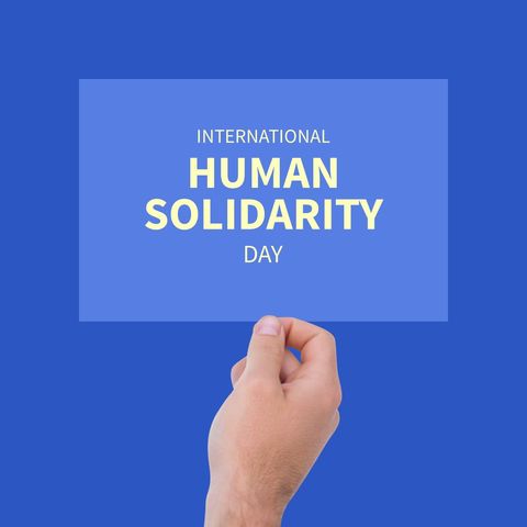 hand holding board celebrating international human solidarity day - Download Free Stock Templates Pikwizard.com