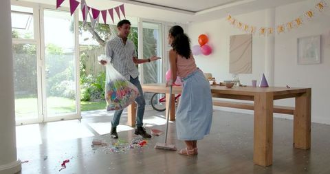 Family Clearing After Celebration Clean Family Home Together