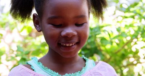 Joyful Schoolgirl Smiling While Using Smartphone Outdoors