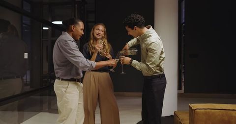 Colleagues socializing at office evening gathering