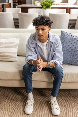 Casually Dressed Male Relaxing in Modern Living Room